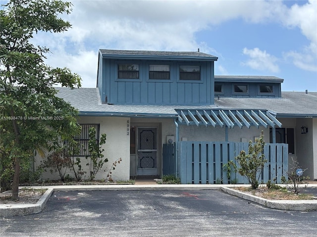 6992 Woodscape Cir Unit 6-T, Miramar, FL 33023 - view of front facade featuring uncovered parking, a shingled roof, and stucco siding