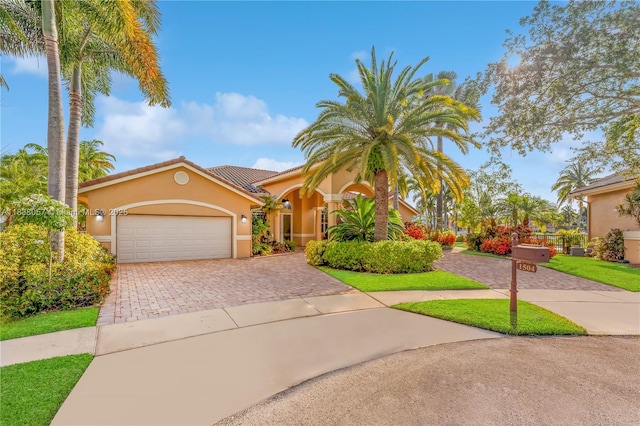 1504 NW 182nd Ave, Pembroke Pines, FL 33029 - mediterranean / spanish home with stucco siding, decorative driveway, a garage, and a tiled roof