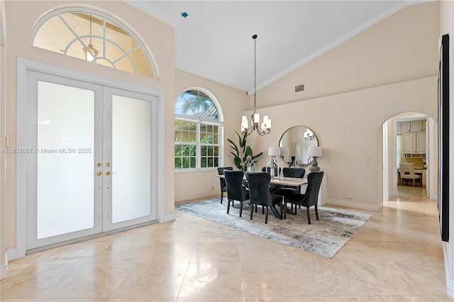 1504 NW 182nd Ave, Pembroke Pines, FL 33029 - dining area featuring arched walkways, french doors, high vaulted ceiling, a chandelier, and ornamental molding