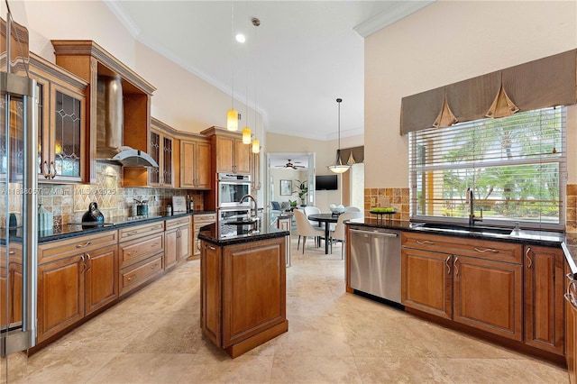 1504 NW 182nd Ave, Pembroke Pines, FL 33029 - kitchen with stainless steel appliances, crown molding, wall chimney range hood, brown cabinetry, and decorative backsplash