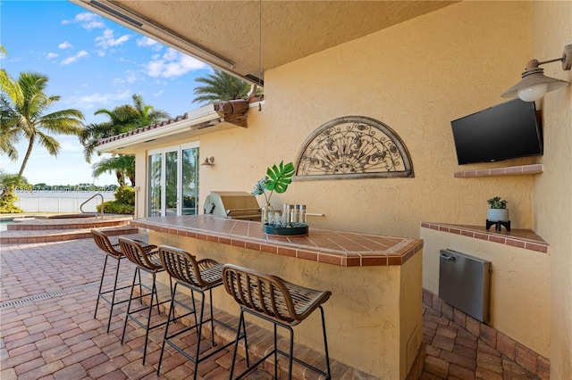 1504 NW 182nd Ave, Pembroke Pines, FL 33029 - view of patio / terrace featuring a water view and exterior kitchen