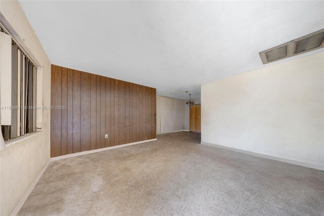 3300 NW 211th St, Miami Gardens, FL 33056 - unfurnished room with wooden walls and carpet