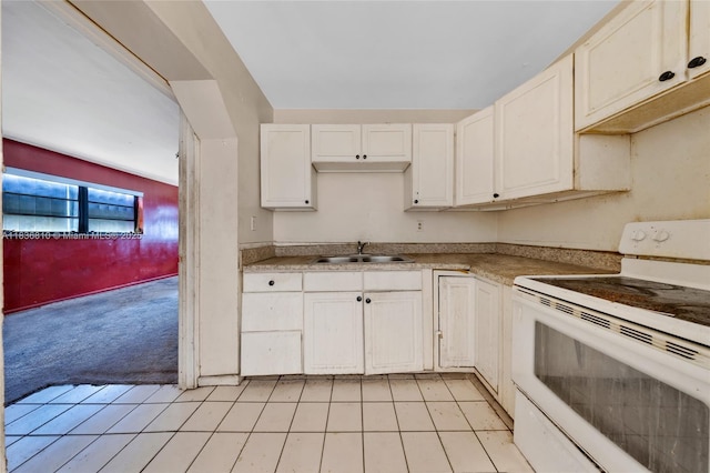 3300 NW 211th St, Miami Gardens, FL 33056 - kitchen featuring electric range, light colored carpet, light countertops, and white cabinetry