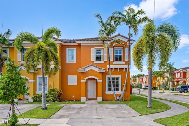 771 SE 2nd St, Homestead, FL 33030 - view of property with stucco siding, a tiled roof, and a front lawn