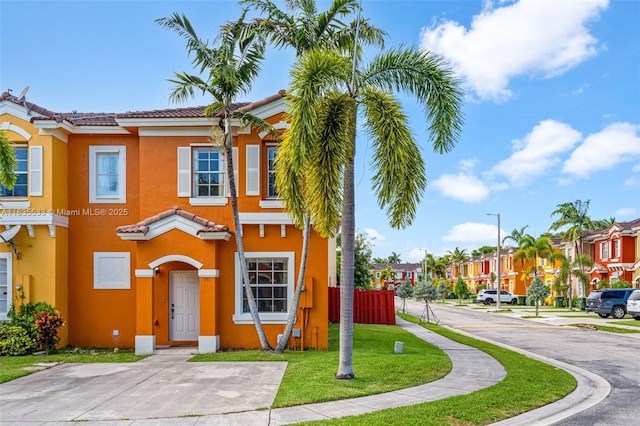 771 SE 2nd St, Homestead, FL 33030 - view of property with stucco siding, a tiled roof, and a residential view