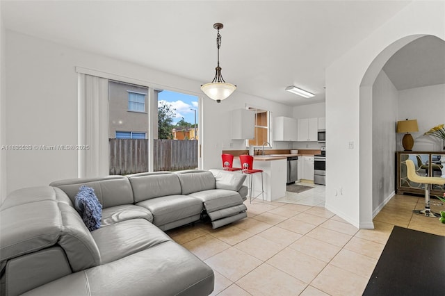 771 SE 2nd St, Homestead, FL 33030 - living room featuring arched walkways and light tile patterned floors