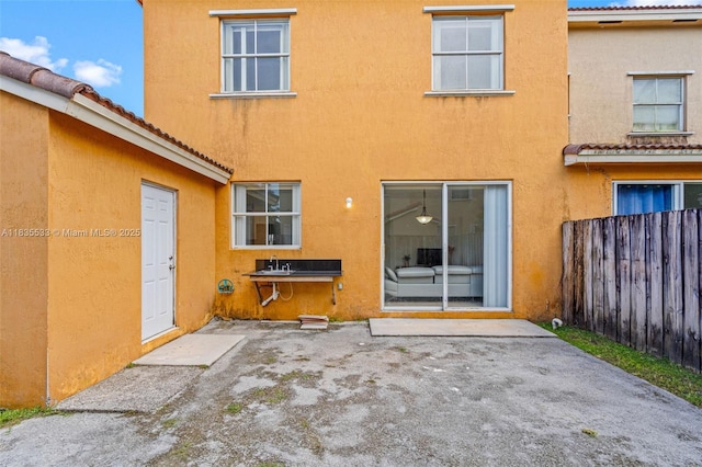 771 SE 2nd St, Homestead, FL 33030 - rear view of house featuring stucco siding, a patio area, and a tile roof