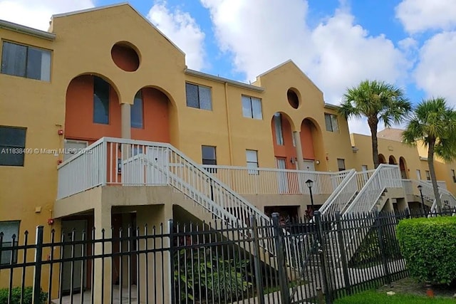 5200 NW 31st Ave Unit 217, Fort Lauderdale, FL 33309 - view of property with stairs and a fenced front yard