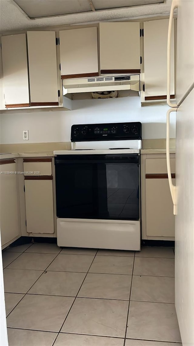 5200 NW 31st Ave Unit 217, Fort Lauderdale, FL 33309 - kitchen featuring electric stove, under cabinet range hood, light countertops, and light tile patterned flooring