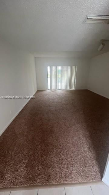 5200 NW 31st Ave Unit 217, Fort Lauderdale, FL 33309 - carpeted empty room featuring a textured ceiling