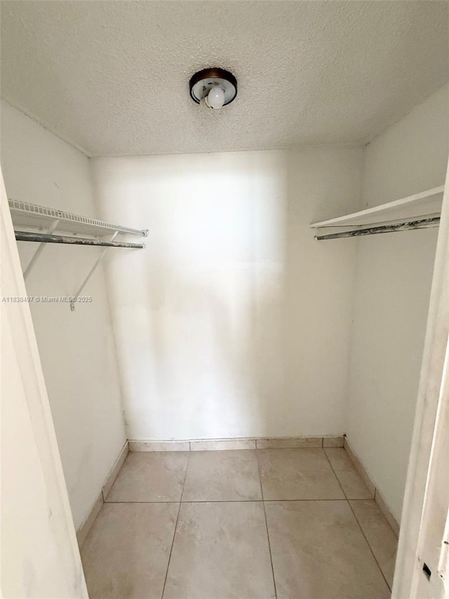 15600 NW 7th Ave Unit 807, Miami, FL 33169 - walk in closet featuring light tile patterned flooring