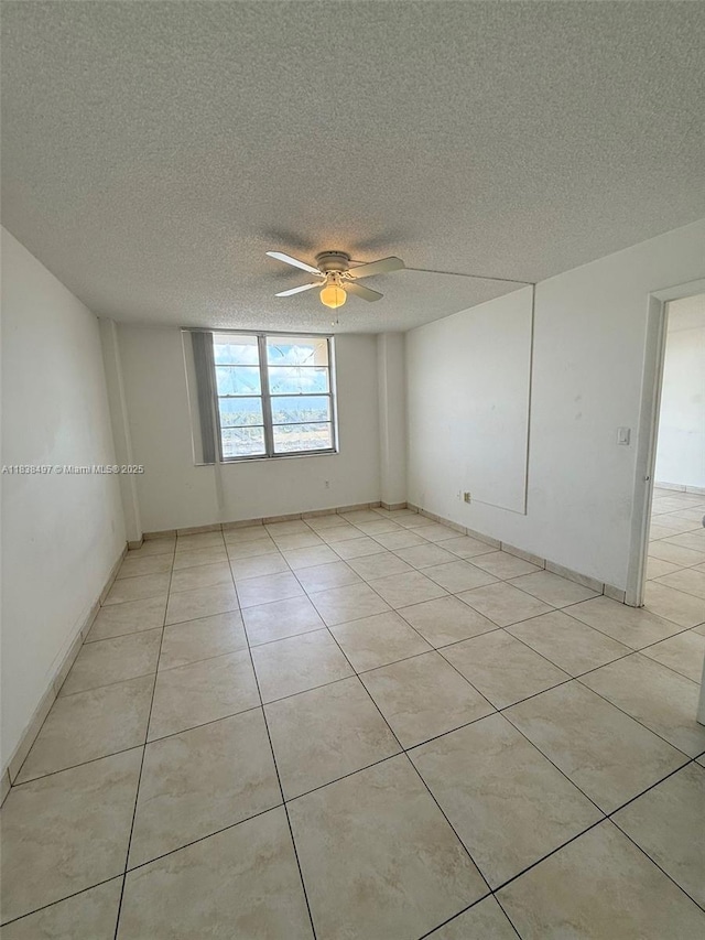 15600 NW 7th Ave Unit 807, Miami, FL 33169 - spare room featuring a textured ceiling, ceiling fan, and light tile patterned floors