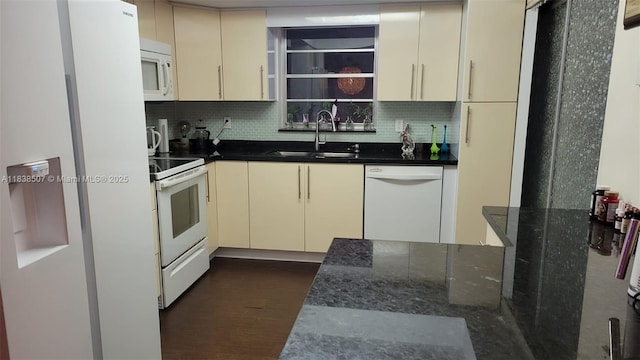 200 NE 12th Ave Unit 7B, Hallandale Beach, FL 33009 - kitchen with white appliances, cream cabinets, backsplash, and dark stone counters
