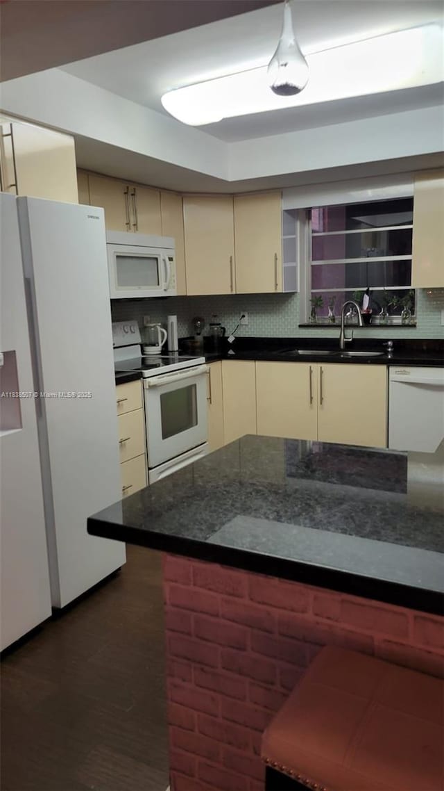200 NE 12th Ave Unit 7B, Hallandale Beach, FL 33009 - kitchen featuring white appliances, dark countertops, tasteful backsplash, cream cabinetry, and dark wood-style flooring