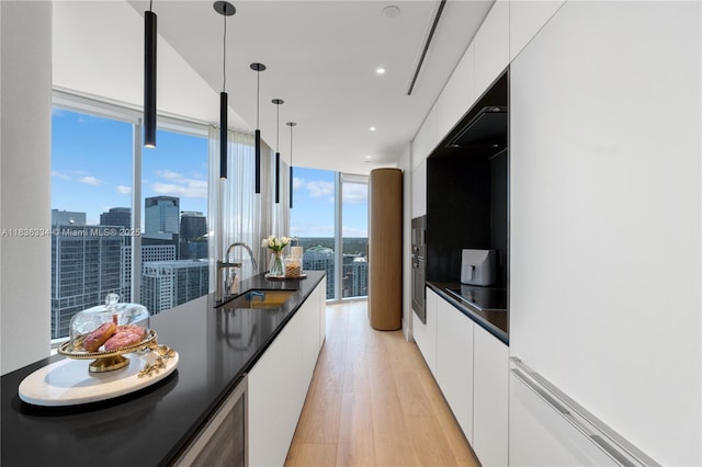 300 Biscayne Blvd Way Unit 4707, Miami, FL 33131 - kitchen with modern cabinets, dark countertops, white cabinetry, and recessed lighting