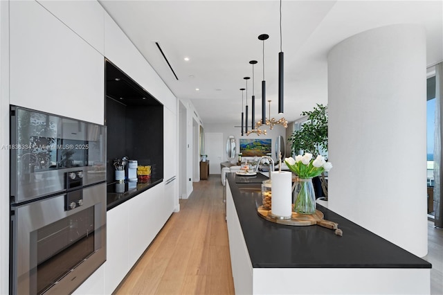 300 Biscayne Blvd Way Unit 4707, Miami, FL 33131 - kitchen featuring modern cabinets, white cabinets, dark countertops, light wood-style floors, and recessed lighting