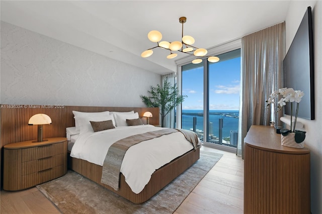300 Biscayne Blvd Way Unit 4707, Miami, FL 33131 - bedroom featuring a wall of windows, access to outside, light wood finished floors, and a chandelier