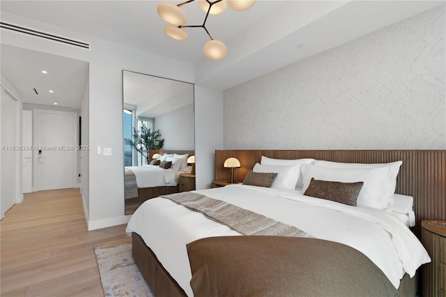 300 Biscayne Blvd Way Unit 4707, Miami, FL 33131 - bedroom with light wood-type flooring and a chandelier