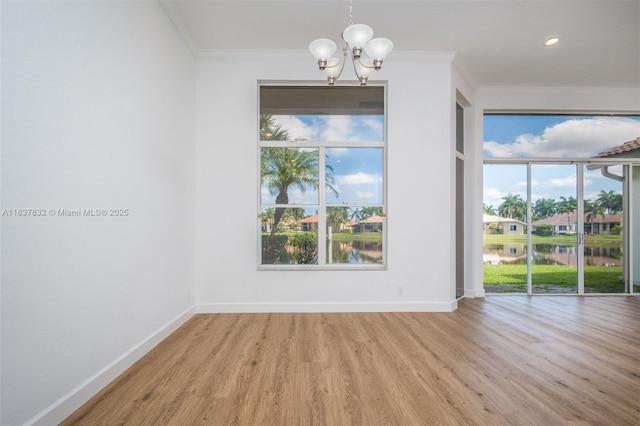 2664 Edgewater Dr, Weston, FL 33332 - empty room with ornamental molding, wood finished floors, a chandelier, plenty of natural light, and a water view