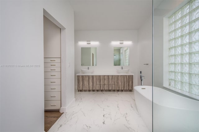 2664 Edgewater Dr, Weston, FL 33332 - full bath featuring a freestanding bath, double vanity, marble look tile flooring, and plenty of natural light