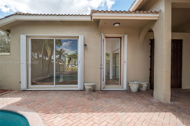 2664 Edgewater Dr, Weston, FL 33332 - rear view of house with a patio, stucco siding, and a tile roof