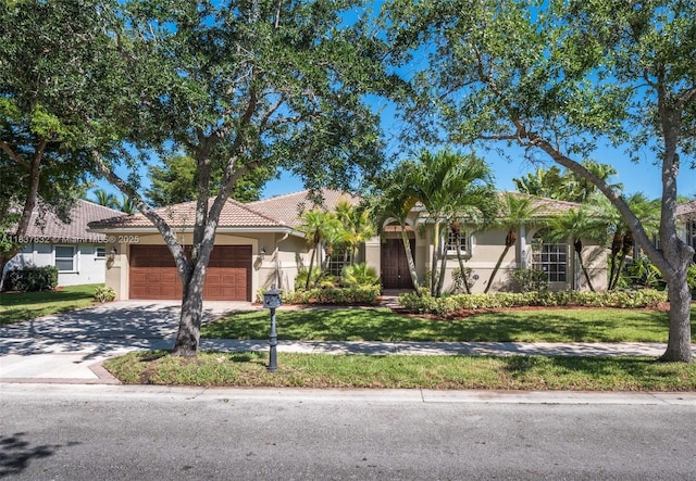 2664 Edgewater Dr, Weston, FL 33332 - view of front of home featuring stucco siding, an attached garage, and a front yard