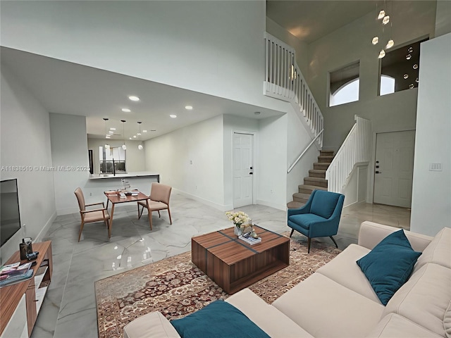 1470 Sweetbay Way, Hollywood, FL 33019 - living room featuring light marble finish flooring, stairway, recessed lighting, a towering ceiling, and plenty of natural light
