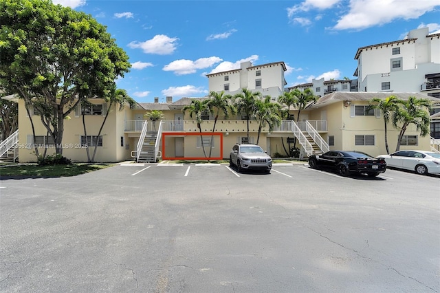 7304 SW 82nd St Unit A107, Miami, FL 33143 - uncovered parking lot featuring stairs and a residential view
