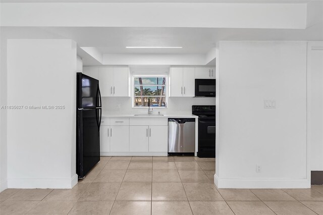 7304 SW 82nd St Unit A107, Miami, FL 33143 - kitchen with black appliances, light countertops, white cabinetry, and light tile patterned flooring