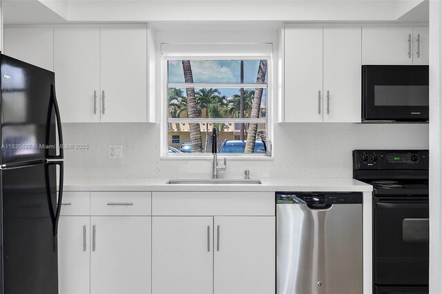 7304 SW 82nd St Unit A107, Miami, FL 33143 - kitchen with black appliances, light countertops, and white cabinetry