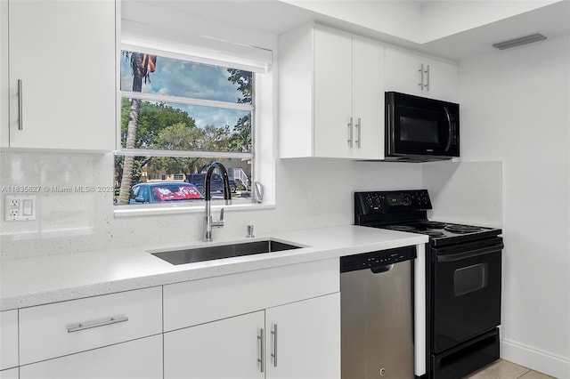 7304 SW 82nd St Unit A107, Miami, FL 33143 - kitchen with black appliances, white cabinets, tasteful backsplash, and light stone counters