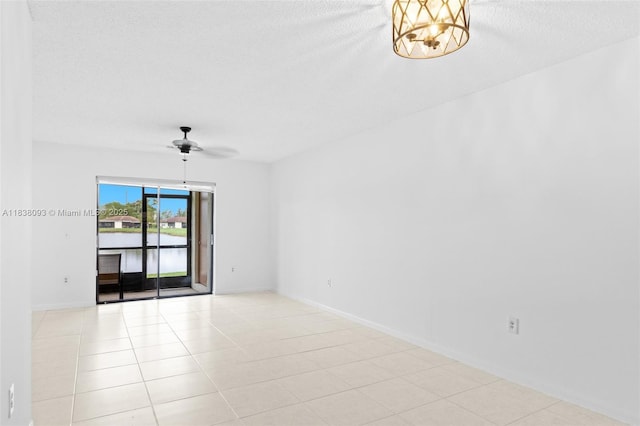 3057 NW 109th Ave Unit 3057, Sunrise, FL 33322 - tiled spare room with a textured ceiling, ceiling fan, and a chandelier
