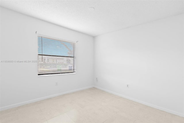 3057 NW 109th Ave Unit 3057, Sunrise, FL 33322 - unfurnished room with baseboards and a textured ceiling