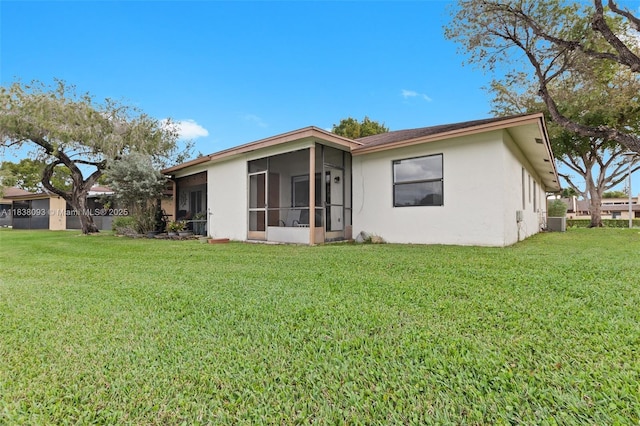 3057 NW 109th Ave Unit 3057, Sunrise, FL 33322 - back of house with stucco siding, a yard, and a sunroom