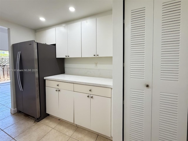8650 SW 109th Ave Unit 3-112, Miami, FL 33173 - kitchen with freestanding refrigerator, light tile patterned floors, light countertops, white cabinets, and recessed lighting
