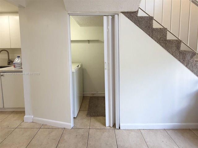 8650 SW 109th Ave Unit 3-112, Miami, FL 33173 - hall featuring light tile patterned floors, washer / dryer, a textured ceiling, and stairs