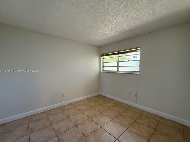 8650 SW 109th Ave Unit 3-112, Miami, FL 33173 - unfurnished room with a textured ceiling and light tile patterned flooring