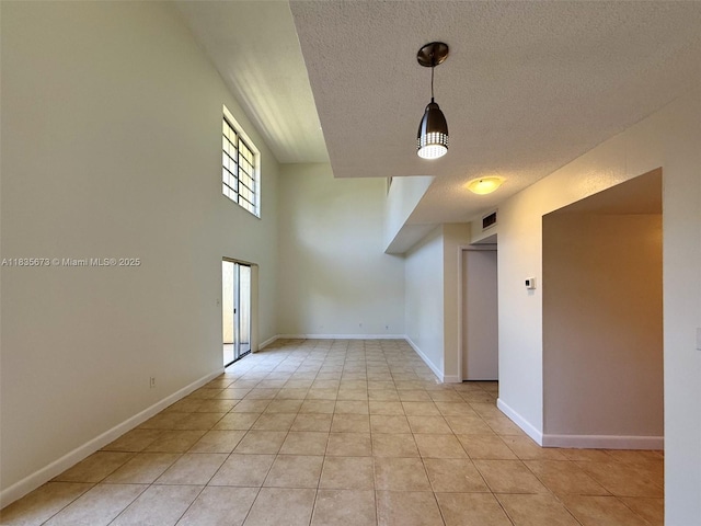 8650 SW 109th Ave Unit 3-112, Miami, FL 33173 - unfurnished room with a textured ceiling and light tile patterned floors