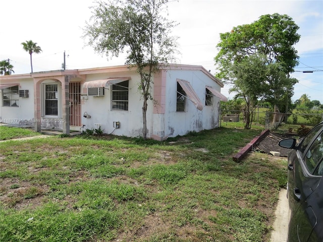 525 NW 16th St, Pompano Beach, FL 33060 - view of front of home featuring a wall unit AC and stucco siding