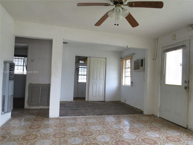 525 NW 16th St, Pompano Beach, FL 33060 - foyer with a wall mounted AC, plenty of natural light, a ceiling fan, and a heating unit