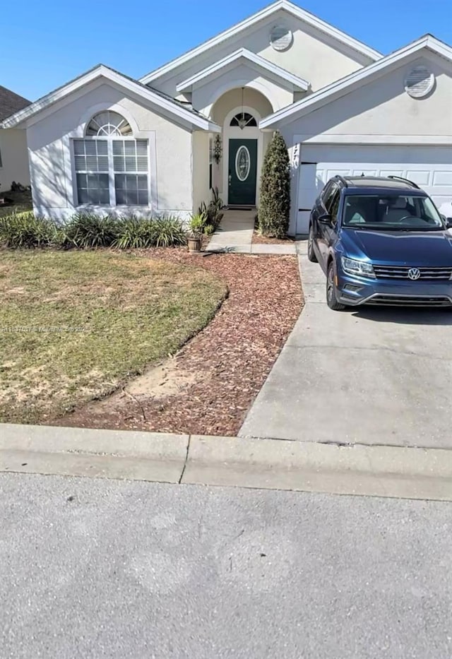 177 Heather Lynn, Davenport, FL 33897 - ranch-style house with concrete driveway, an attached garage, stucco siding, and a front yard