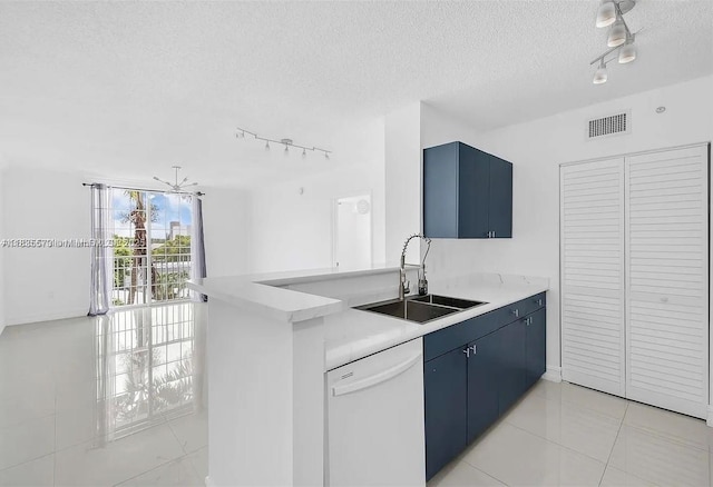 1919 Van Buren St Unit 505A, Hollywood, FL 33020 - kitchen featuring rail lighting, white dishwasher, blue cabinetry, a textured ceiling, and light tile patterned flooring