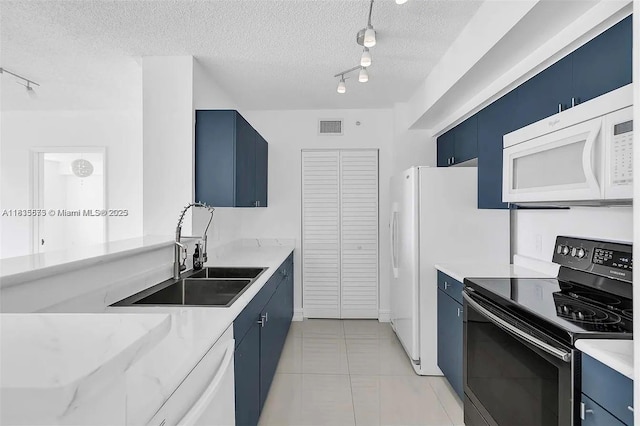 1919 Van Buren St Unit 505A, Hollywood, FL 33020 - kitchen featuring white appliances, blue cabinets, rail lighting, and a textured ceiling