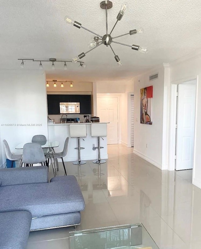 1919 Van Buren St Unit 505A, Hollywood, FL 33020 - tiled living room with a textured ceiling and a chandelier