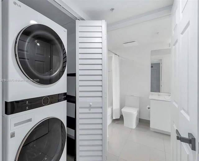 1919 Van Buren St Unit 505A, Hollywood, FL 33020 - washroom with stacked washing machine and dryer and tile patterned floors
