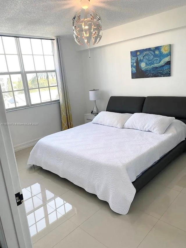 1919 Van Buren St Unit 505A, Hollywood, FL 33020 - bedroom featuring tile patterned floors and a textured ceiling