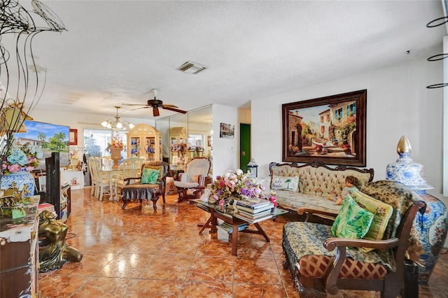 6768 Rose Dr, Miramar, FL 33023 - tiled living area with a chandelier, ceiling fan, and a textured ceiling