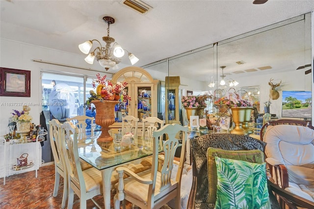 6768 Rose Dr, Miramar, FL 33023 - dining room featuring a chandelier and a textured ceiling