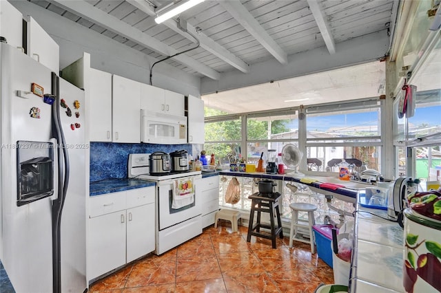 6768 Rose Dr, Miramar, FL 33023 - kitchen with white appliances, tasteful backsplash, white cabinets, beamed ceiling, and dark countertops