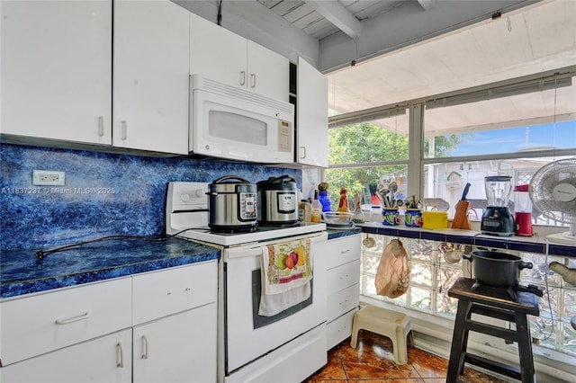 6768 Rose Dr, Miramar, FL 33023 - kitchen with white appliances, decorative backsplash, white cabinetry, beam ceiling, and dark tile patterned flooring